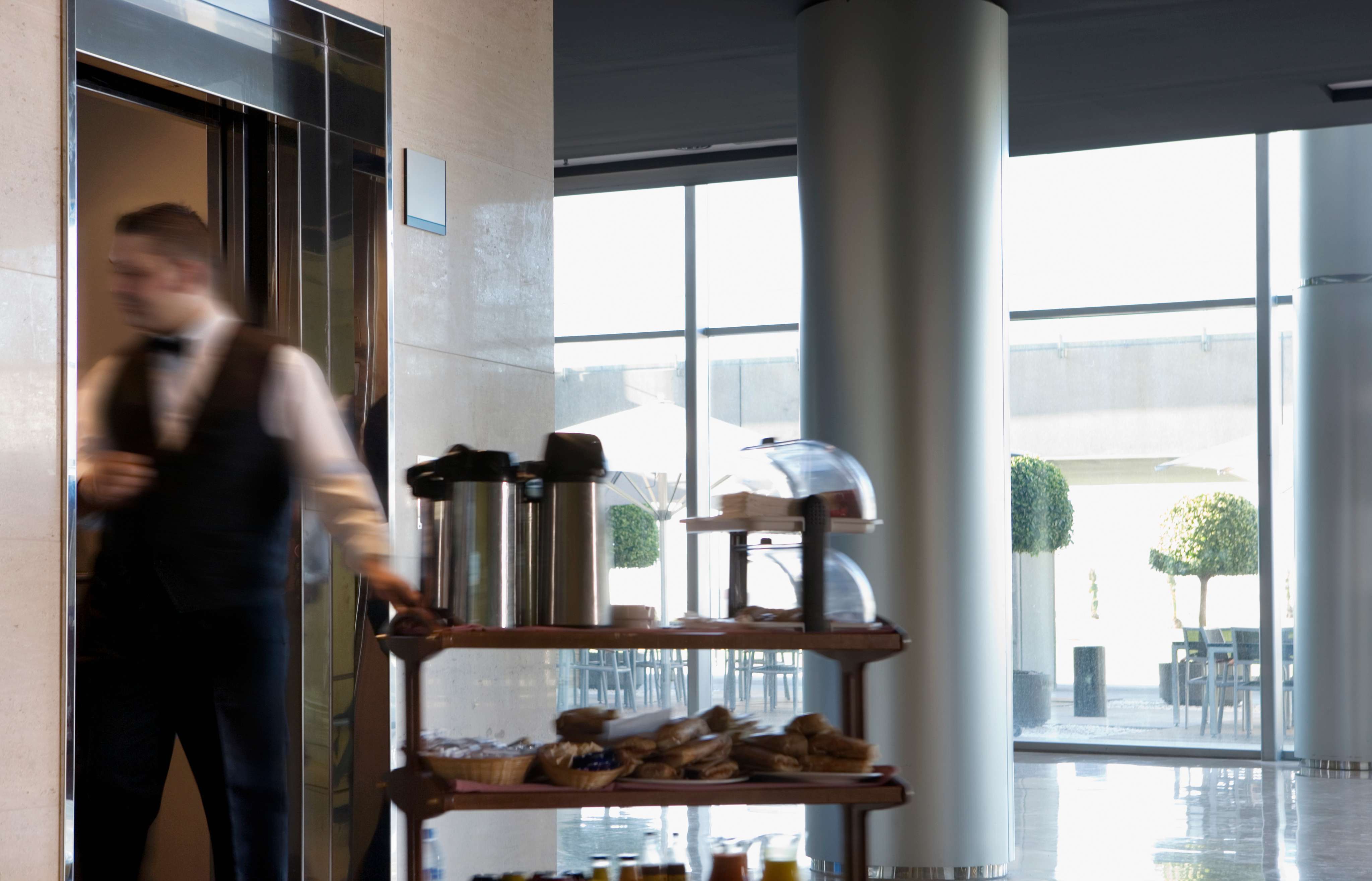 Waiter entering hotel elevator